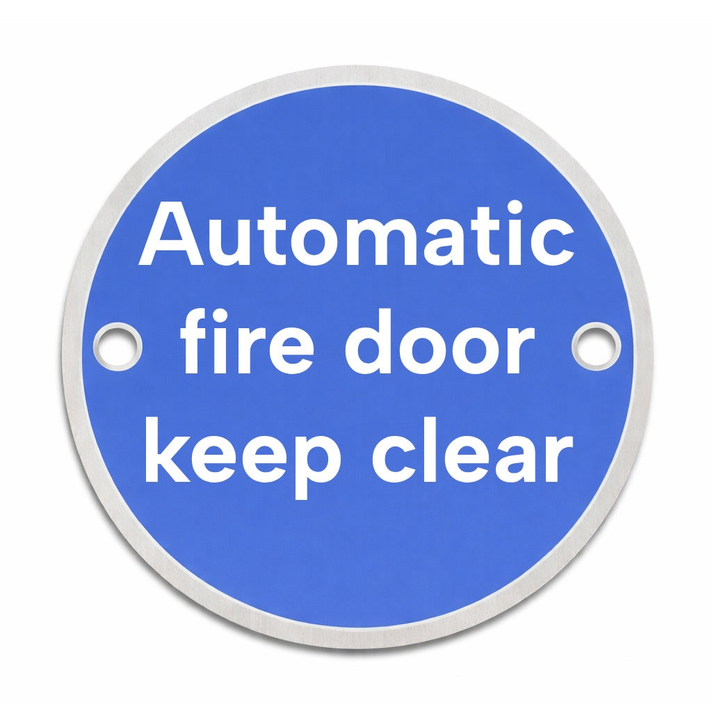 Blue circular rigid metal sign with 'Automatic fire door keep clear' text and fixing holes